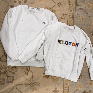 2 white peloton sweatshirts